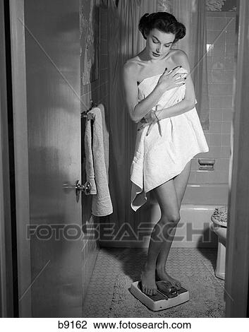 1950S Woman Wrapped In Towel Stepping On Bathroom Scale View Large Photo Image Stock Image - 1950S Woman Wrapped In Towel Stepping On Bathroom Scale. Fotosearch