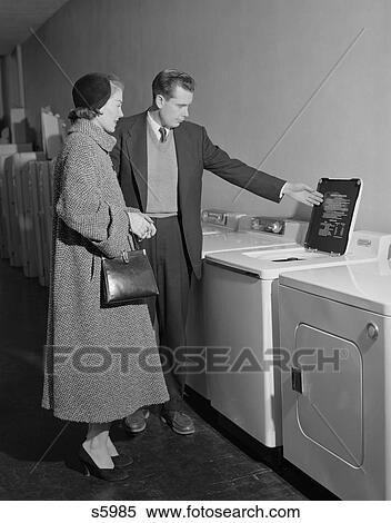 Stock Photography - 1950S Young Couple Man Woman Shopping For Washing Machine . Fotosearch