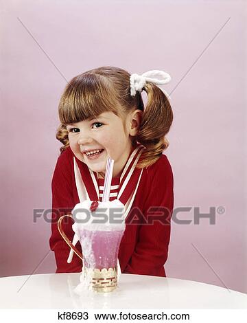 1960S 19670S Happy Little Girl With Ice Cream Soda Studio Ponytail View Large Photo Image Stock Image - 1960S 19670S Happy Little Girl With Ice Cream Soda Studio Ponytail. Fotosearch