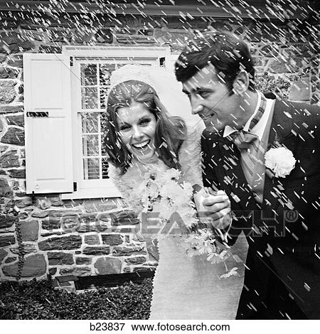 1960S 1970S Bride & Groom Portrait With Rice Being Thrown View Large Photo Image Stock Photo - 1960S 1970S Bride & Groom Portrait With Rice Being Thrown. Fotosearch