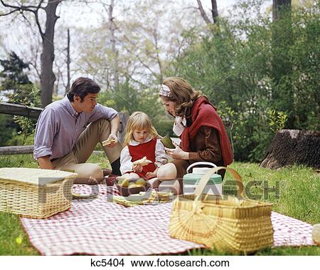 1960S 1970S Family Mother Father Girl Spring Picnic On Checkered Tablecloth View Large Photo Image Picture - 1960S 1970S Family Mother Father Girl Spring Picnic On Checkered Tablecloth . Fotosearch