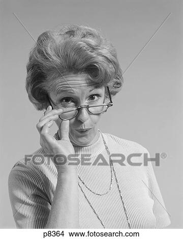 1960S 1970S Mature Woman Looking Over The Top Of Her Eyeglasses Funny Facial Expression Looking At Camera View Large Photo Image Picture - 1960S 1970S Mature Woman Looking Over The Top Of Her Eyeglasses Funny Facial Expression Looking At Camera. Fotosearch