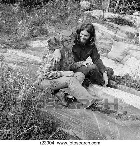 Picture - 1960S 1970S Romantic Young Hippie Couple Sitting Outdoors. Fotosearch