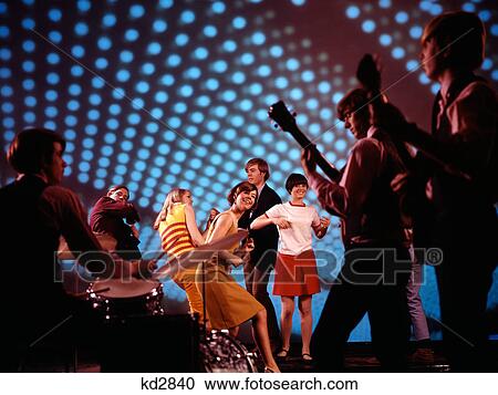 1960S 1970S Teenagers Dancing At Discotheque With Band Playing Music Blue Lighting Effects View Large Photo Image Stock Image - 1960S 1970S Teenagers Dancing At Discotheque With Band Playing Music Blue Lighting Effects. Fotosearch