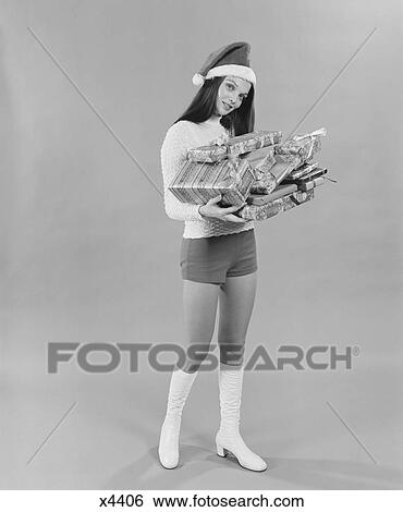 1960S 1970S Young Woman Wearing Santa Claus Hat Hot Pants Go-Go Boots Holding Wrapped Christmas Presents Looking At Camera View Large Photo Image Stock Photograph - 1960S 1970S Young Woman Wearing Santa Claus Hat Hot Pants Go-Go Boots Holding Wrapped Christmas Presents Looking At Camera. Fotosearch