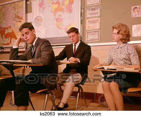 1960S 3 College High School Students Sitting Desk Chairs Reading Studying Classroom View Large Photo Image Stock Image - 1960S 3 College High School Students Sitting Desk Chairs Reading Studying Classroom . Fotosearch