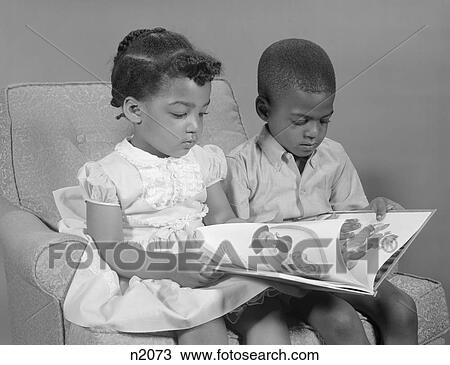 1960S African-American Boy And Girl Reading Book Sitting Chair View Large Photo Image Stock Image - 1960S African-American Boy And Girl Reading Book Sitting Chair. Fotosearch