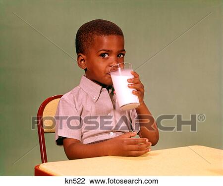 1960S African American Boy Drinking Glass Of Dairy Milk Looking At Camera View Large Photo Image Stock Image - 1960S African American Boy Drinking Glass Of Dairy Milk Looking At Camera. Fotosearch