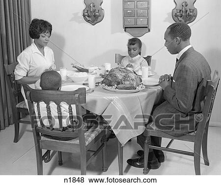 1960S African-American Family At Dining Table With Turkey Saying Grace Praying View Large Photo Image Stock Photo - 1960S African-American Family At Dining Table With Turkey Saying Grace Praying. Fotosearch