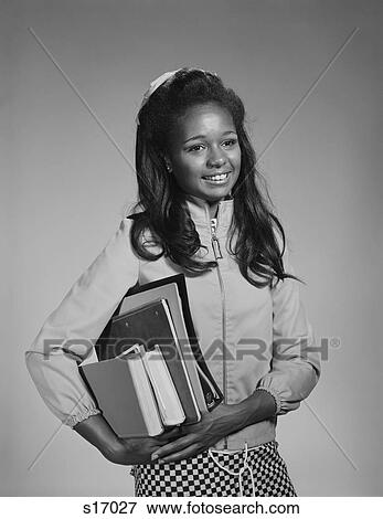 Stock Photo - 1960S African-American Teen Girl Carrying School Books. Fotosearch