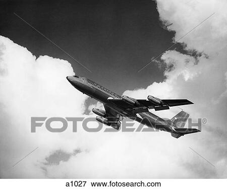1960S American Airlines A-707 Jet Ascending Through Clouds View Large Photo Image Stock Photo - 1960S American Airlines A-707 Jet Ascending Through Clouds . Fotosearch