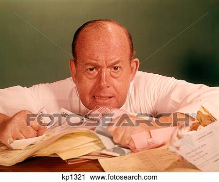 1960S Angry Man Businessman Desk Full Of Bills Paper Work Office Stress Frustration View Large Photo Image Stock Image - 1960S Angry Man Businessman Desk Full Of Bills Paper Work Office Stress Frustration . Fotosearch