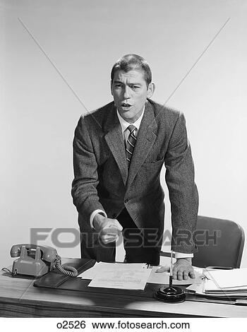1960S Angry Upset Businessman Pounding Fist Into Desk View Large Photo Image Stock Photograph - 1960S Angry Upset Businessman Pounding Fist Into Desk. Fotosearch
