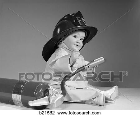 1960S Baby Fireman With Safety Hat Coat And Fire Extinguisher View Large Photo Image Stock Image - 1960S Baby Fireman With Safety Hat Coat And Fire Extinguisher. Fotosearch