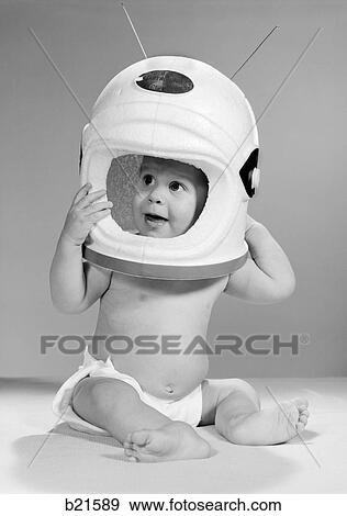 1960S Baby In Diaper Seated Holding Astronaut Helmet With Antennae On Head View Large Photo Image Stock Photo - 1960S Baby In Diaper Seated Holding Astronaut Helmet With Antennae On Head. Fotosearch