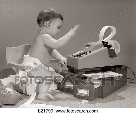 1960S Baby Seated In Small Chair Hitting Keys On Office Adding Machine On Top Of Small File Drawers View Large Photo Image Stock Photo - 1960S Baby Seated In Small Chair Hitting Keys On Office Adding Machine On Top Of Small File Drawers. Fotosearch