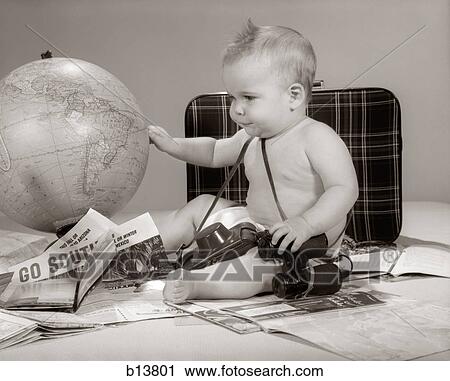 1960S Baby Seated Looking At Globe With Camera Binoculars Suitcase & Travel Brochures View Large Photo Image Stock Image - 1960S Baby Seated Looking At Globe With Camera Binoculars Suitcase & Travel Brochures. Fotosearch
