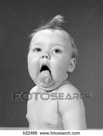 Stock Photograph - 1960S Baby With Curl On Top Of Head & Tongue Sticking Out. Fotosearch