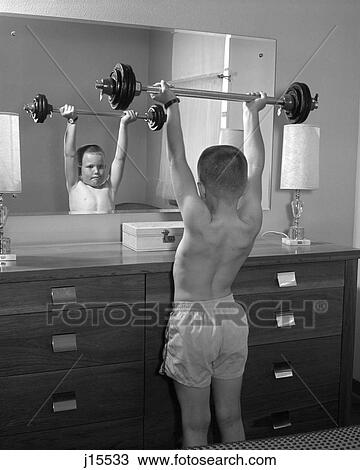 1960S Boy Exercising With Dumbbell At Mirror In Bedroom View Large Photo Image Stock Image - 1960S Boy Exercising With Dumbbell At Mirror In Bedroom. Fotosearch