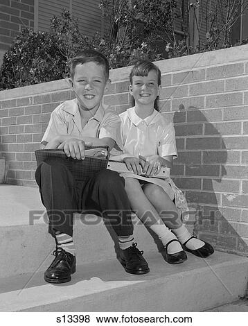 1960S Boy Girl Sitting Steps Holding School Books View Large Photo Image Stock Photo - 1960S Boy Girl Sitting Steps Holding School Books. Fotosearch