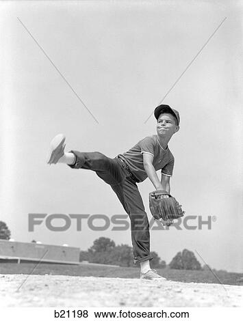 1960S Boy Wearing Baseball Cap Tee Shirt Blue Jeans And Determined Expression In Wind-Up To Deliver Pitch View Large Photo Image Stock Photo - 1960S Boy Wearing Baseball Cap Tee Shirt Blue Jeans And Determined Expression In Wind-Up To Deliver Pitch. Fotosearch