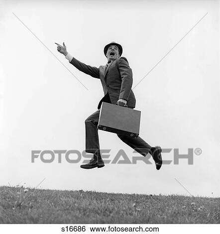 1960S Businessman Carrying A Briefcase Running Yelling And Jumping In The Air Outdoor Pointing Finger Forward View Large Photo Image Stock Photograph - 1960S Businessman Carrying A Briefcase Running Yelling And Jumping In The Air Outdoor Pointing Finger Forward. Fotosearch