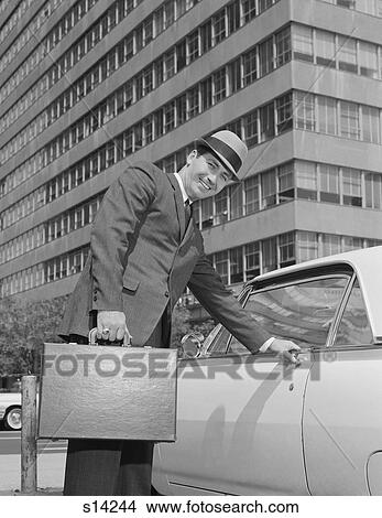 1960S Businessman Carrying Briefcase Getting Into Car On Urban Street View Large Photo Image Picture - 1960S Businessman Carrying Briefcase Getting Into Car On Urban Street. Fotosearch