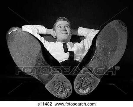 1960S Businessman In Shirtsleeves Hands Behind Head Sitting With Shoes On Desk Daydreaming View Large Photo Image Stock Image - 1960S Businessman In Shirtsleeves Hands Behind Head Sitting With Shoes On Desk Daydreaming. Fotosearch