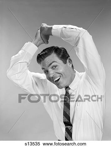 1960S Businessman In Shirtsleeves Clasping Hands Together Overhead Smiling Symbolic Success Winning Studio Indoor View Large Photo Image Stock Photography - 1960S Businessman In Shirtsleeves Clasping Hands Together Overhead Smiling Symbolic Success Winning Studio Indoor. Fotosearch