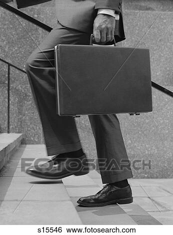 Stock Photograph - 1960S Businessman Legs Walking Up Stairs Hand Holding Briefcase. Fotosearch