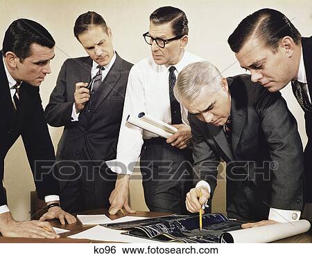 1960S Businessmen Meeting Inspecting Blueprints Not For Use With: Beer, Cigars, Cigarettes, Soap, Toothpaste, Mouthwash, Coffee, Tea, Or Soft Drinks View Large Photo Image Stock Photograph - 1960S Businessmen Meeting Inspecting Blueprints Not For Use With: Beer, Cigars, Cigarettes, Soap, Toothpaste, Mouthwash, Coffee, Tea, Or Soft Drinks. Fotosearch
