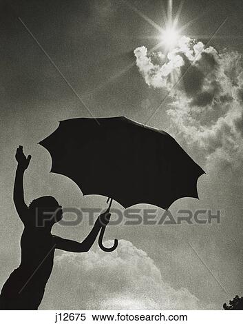 1960S Child Silhouette Standing With Umbrella Under Bright Sun View Large Photo Image Stock Photography - 1960S Child Silhouette Standing With Umbrella Under Bright Sun. Fotosearch