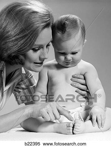 Stock Photography - 1960S Close-Up Of Mother Counting Toes Of Seated Baby Playing This Little Piggy. Fotosearch