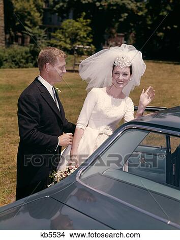 1960S Couple Bride & Groom Getting Into Car After Wedding View Large Photo Image Picture - 1960S Couple Bride & Groom Getting Into Car After Wedding . Fotosearch