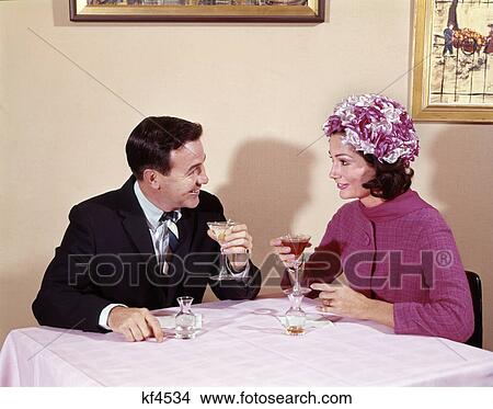 Picture - 1960S Couple Drinking Cocktails At Table Husband Wife Indoor . Fotosearch
