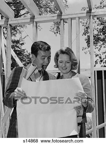 1960S Couple Looking At House Plans Blueprints Man Smoking Pipe View Large Photo Image Stock Photo - 1960S Couple Looking At House Plans Blueprints Man Smoking Pipe. Fotosearch