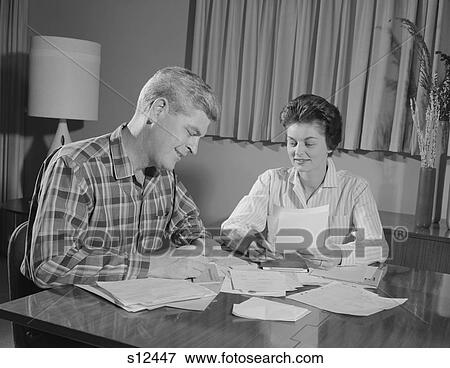 1960S Couple Man Woman At Table Working On Household Accounts Bills View Large Photo Image Stock Photo - 1960S Couple Man Woman At Table Working On Household Accounts Bills. Fotosearch