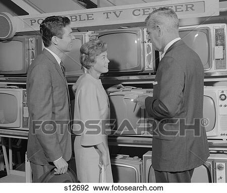 1960S Couple Shopping For Portable Tv Being Helped By Salesman View Large Photo Image Stock Image - 1960S Couple Shopping For Portable Tv Being Helped By Salesman . Fotosearch