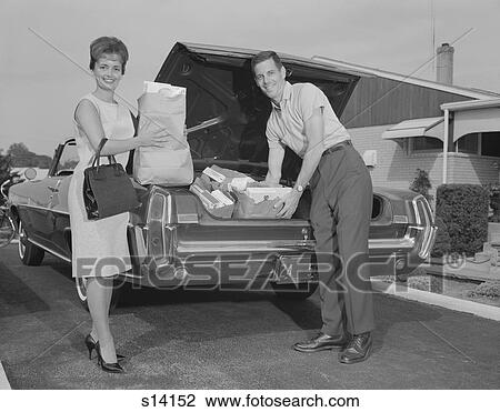 1960S Couple Unpacking Grocery Bags From Automobile Trunk View Large Photo Image Stock Image - 1960S Couple Unpacking Grocery Bags From Automobile Trunk. Fotosearch