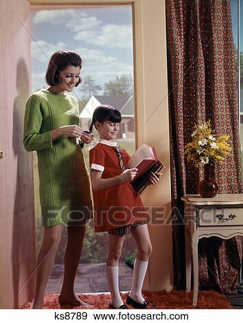 1960S Daughter Reading Book While Mother Is Braiding Her Hair Indoor View Large Photo Image Stock Photo - 1960S Daughter Reading Book While Mother Is Braiding Her Hair Indoor . Fotosearch