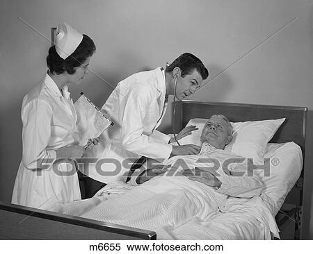 1960S Doctor And Nurse Checking On Elderly Male Patient In Hospital Bed View Large Photo Image Stock Photography - 1960S Doctor And Nurse Checking On Elderly Male Patient In Hospital Bed. Fotosearch