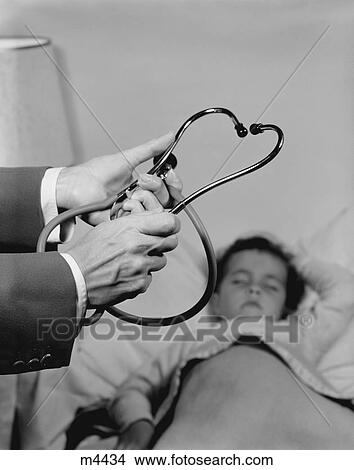 1960S Doctor Hands Holding Stethoscope Little Girl Patient Sleeping At Home View Large Photo Image Picture - 1960S Doctor Hands Holding Stethoscope Little Girl Patient Sleeping At Home. Fotosearch