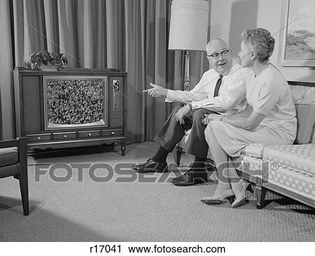 1960S Elderly Couple Sitting On Couch Watching Television View Large Photo Image Stock Image - 1960S Elderly Couple Sitting On Couch Watching Television. Fotosearch