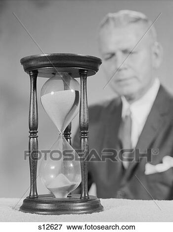 1960S Elderly Man Soft Focus Behind Hourglass View Large Photo Image Stock Photo - 1960S Elderly Man Soft Focus Behind Hourglass . Fotosearch