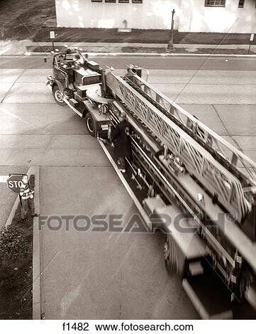 1960S Elevated View Hook And Ladder Fire Truck Leaving The Fire Station View Large Photo Image Stock Image - 1960S Elevated View Hook And Ladder Fire Truck Leaving The Fire Station. Fotosearch