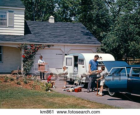 1960S Family Father Mother Sons Loading Car And Trailer For Outdoor Summer Vacation View Large Photo Image Stock Image - 1960S Family Father Mother Sons Loading Car And Trailer For Outdoor Summer Vacation . Fotosearch