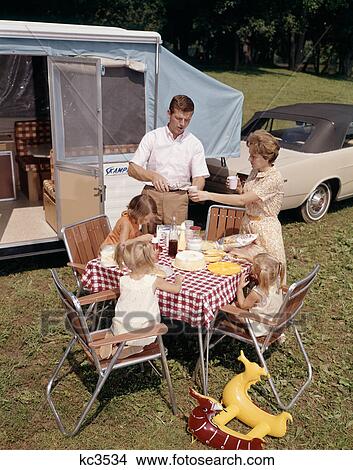 1960S Family Father Mother Three Daughters Eating Meal By Rv Camper View Large Photo Image Picture - 1960S Family Father Mother Three Daughters Eating Meal By Rv Camper . Fotosearch