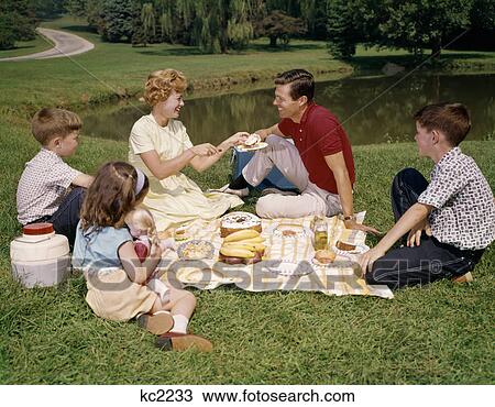 1960S Family Mother Father Daughter And Two Sons Picnicking In Park Outdoor View Large Photo Image Stock Image - 1960S Family Mother Father Daughter And Two Sons Picnicking In Park Outdoor . Fotosearch