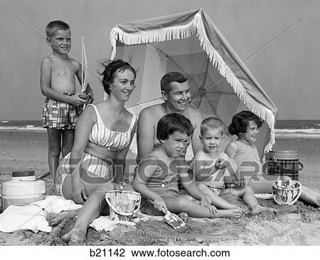 1960S Family Of 6 On Beach Under Umbrella With Pails And Coolers View Large Photo Image Stock Image - 1960S Family Of 6 On Beach Under Umbrella With Pails And Coolers. Fotosearch