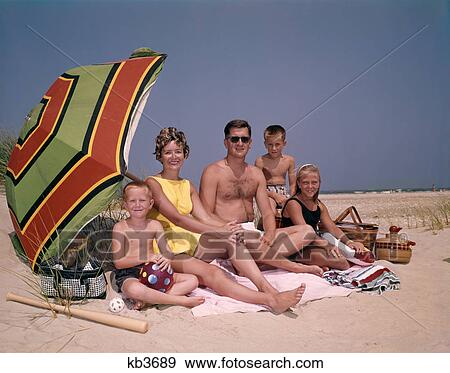 1960S Family On Sunny Beach Under Umbrella With Picnic Basket View Large Photo Image Stock Photo - 1960S Family On Sunny Beach Under Umbrella With Picnic Basket . Fotosearch